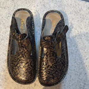 Alegria “Etched Floral Print” Comfortable Leather clogs with embellished buckle.